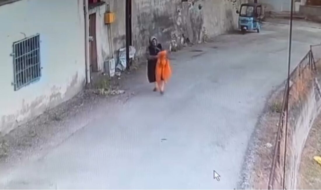 Karabük’te bir kadın, sokakta kurutmak için elektrik direğine asılan yatak